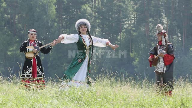 Girls play folk stringed instruments and dance Ural, Salavatsky district, holiday, national...