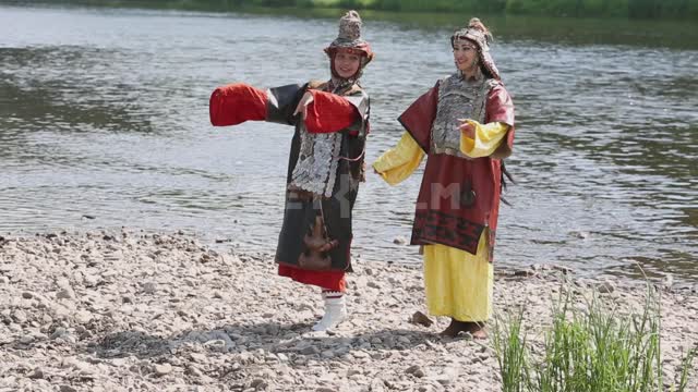 Girls in national costumes rehearse on the river bank Ural, Salavatsky district, girls, national...