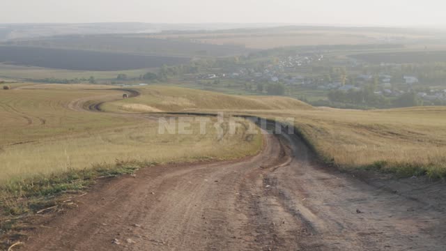 Проселочная дорога, на дальнем плане виден легковой автомобиль Урал, поля, дороги, автомобили,...
