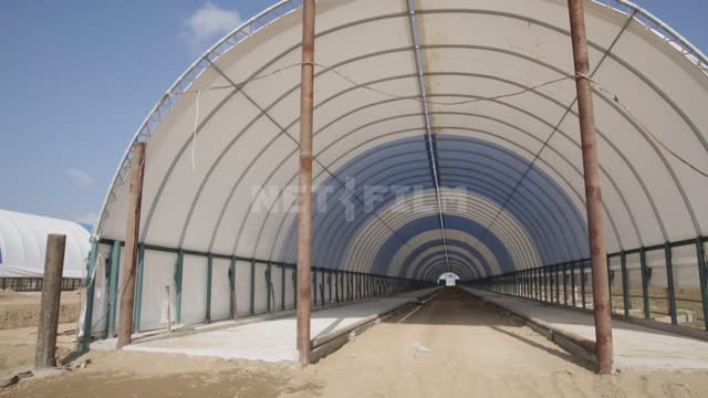 Hangar frames under blue and white awnings Ural, agriculture, construction, construction site,...