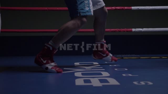 Feet two boxers sparring in the ring.
Slow motion. Boxing
Boxers
Feet
The ring
Ropes