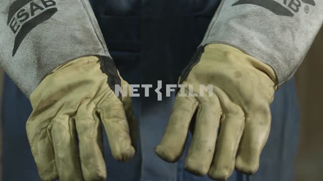 A man shows his hands and removes gloves Work, gloves, hands, fingers, close-up