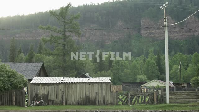 Wooden house on a background of a hill House, people, rain, drops, trees, village, barn, hills,...