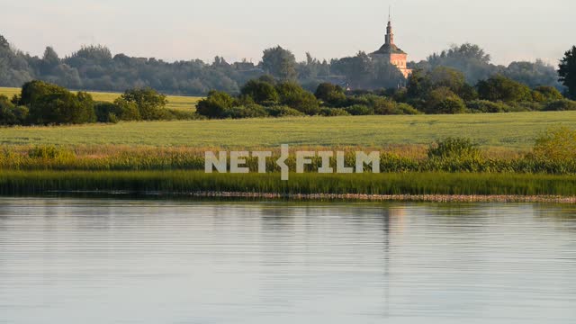 The view of the river and the field.
The temple in the distance River, shore, field, bushes, trees,...