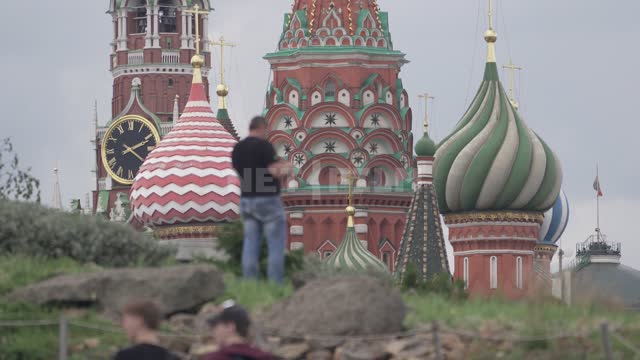 Мужчина фотографирует вид на Покровский собор и Спасскую башню Кремля Кремль, Храм Василия...