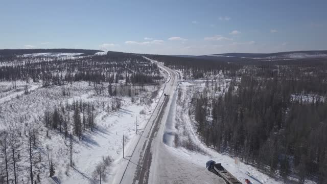 Aerial survey of the road in the Siberian taiga Road, taiga, Siberia