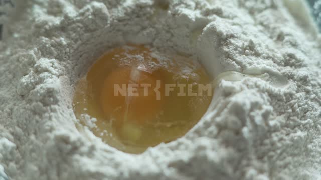 In the flour, break the egg Flour, egg, white, yolk, cooking, baking, food
