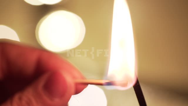 A man lights an incense stick Incense stick, match, fire