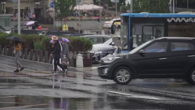 People on a rainy day on the streets of Moscow People, pedestrians, cars, urban transport,...