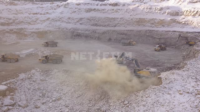 Gold mining, excavators pour ore into trucks Gold mine, quarry, gold mining, minerals, mining,...