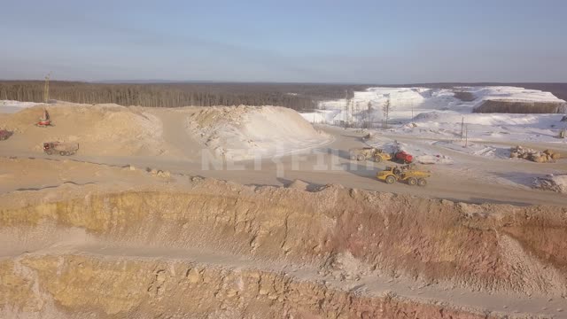 Gold mining, dump trucks take ore out of the quarry Gold mine, quarry, gold mining, minerals,...