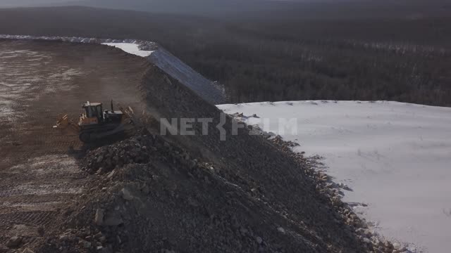 Gold mining, a bulldozer drops the ground down and levels the site Gold mine, quarry, gold mining,...
