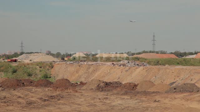 Sand quarry, dumps, in the background flying plane Quarry, dump, earth, clay, construction...