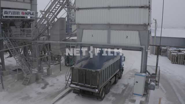 Asphalt concrete plant, bituminous concrete is poured into a truck ABZ, asphalt mixing plant, dump...