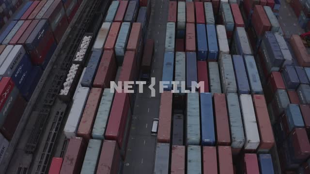 Seaport, container warehouse, truck rides down the aisle Port, warehouse, containers, truck, aerial...