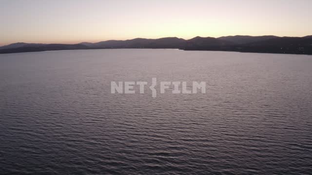 Sunset over the sea Sea, mountains, sky, sunset, coast, aerial photography