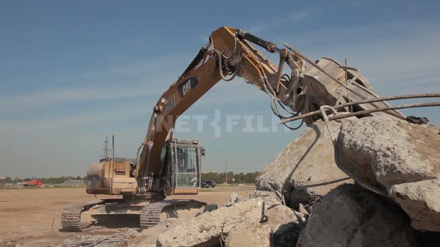 An excavator with a narrow bucket rakes the blockage Excavator, construction equipment, road...