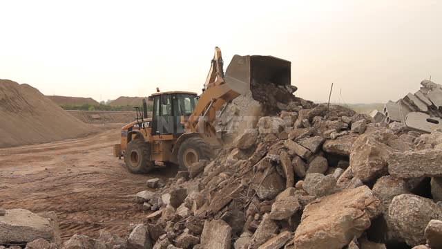 A bulldozer and an excavator with a narrow bucket rake the blockage Excavator, bulldozer,...