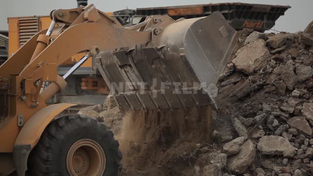 Bulldozer clears the rubble, rakes up the stones Bulldozer, excavator, grader, road equipment,...