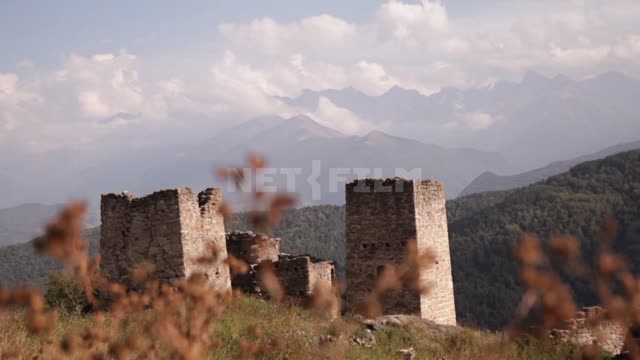Meadow grass on the background of an old fortress in the mountains Mountains, fortress, towers,...