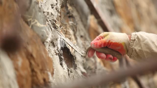 The builder puts cement over the cracks in the stones Wall, stones, Cement, Mortar, builder,...
