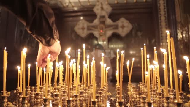 Cathedral of Christ the Saviour, a man puts a candle in front of the altar Cathedral of Christ the...
