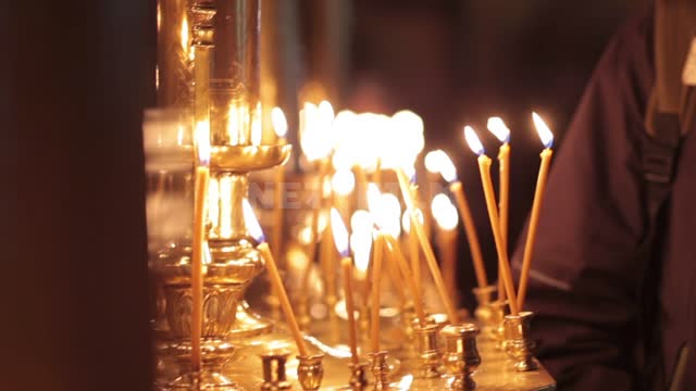 Trinity-St. Sergius Lavra, candles are burning on the altar, people are standing nearby...