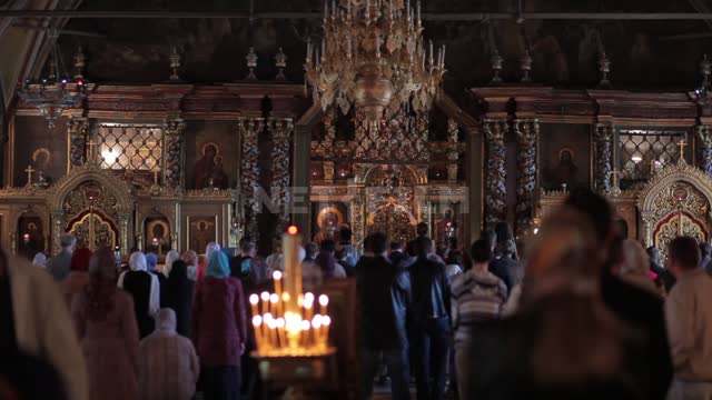 Trinity-St. Sergius Lavra, parishioners in the church, the light goes out behind the iconostasis...