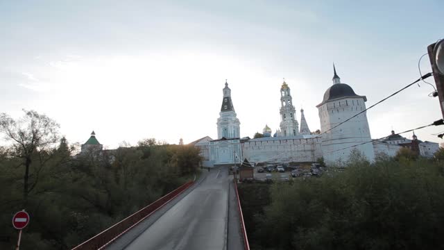 Trinity-St. Sergius Lavra, view from the side of the bridge, a woman walks on the bridge, shooting...