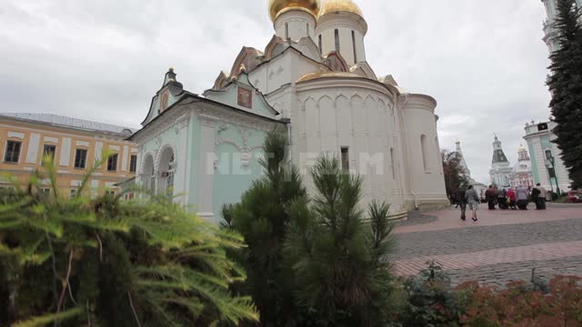Trinity-Sergius Lavra, Holy Trinity Cathedral, view from the side of the flowerbed with coniferous...