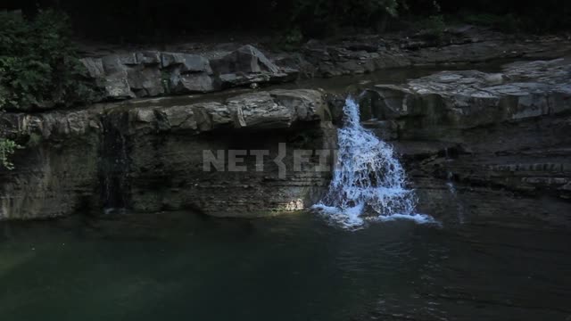 Dolmens of the Western Caucasus, mountain river, waterfall, shooting with the camera moving back...