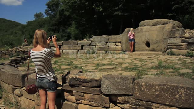 Tourists are photographed against the background of the Caucasian dolmens Nature, people, stones,...