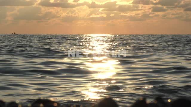 Sochi, sunset over the sea, waves rushing on the shore, sun glare on the water Sochi, Black Sea,...