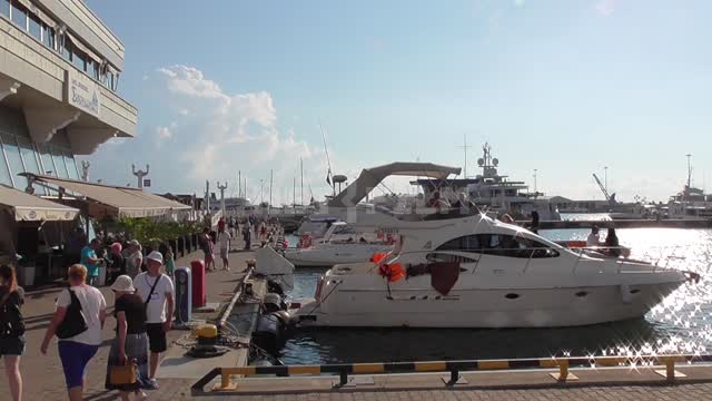Sea port, moored yachts, tourists go Port, boats, pier, black sea, wave, tourist, holiday,...