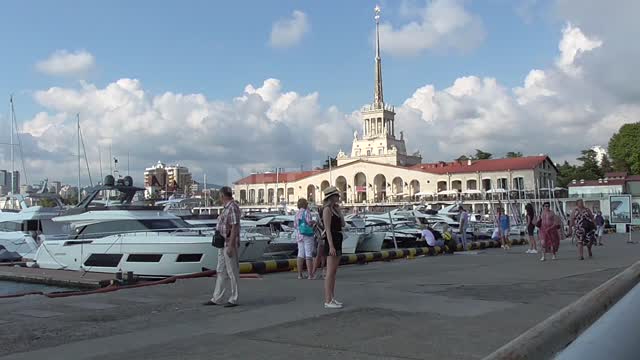The building of the seaport on the embankment of Sochi, yachts are moored, tourists go Port, boats,...