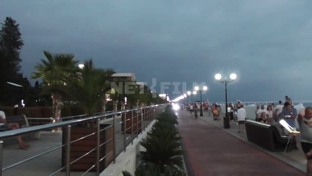 Evening Olympic embankment, people walking along the embankment, bike path Embankment, black sea,...