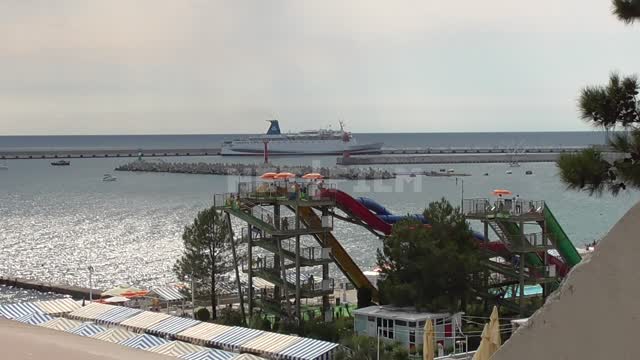 View from the top of the water park on the background of the Black Sea, a ship in the distance...