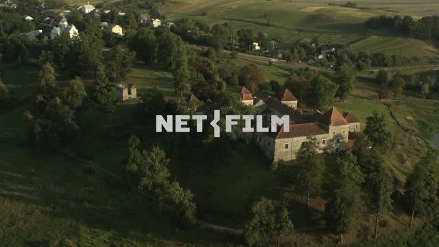 Flight over the monastery.
 Aerial photography.
Monastery.
Church.
Green trees.
Road.
The...