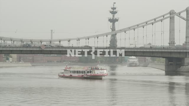 Ship sails under Crimean bridge. Close-up.
A gloomy sky.
The Moscow river.
Crimean...