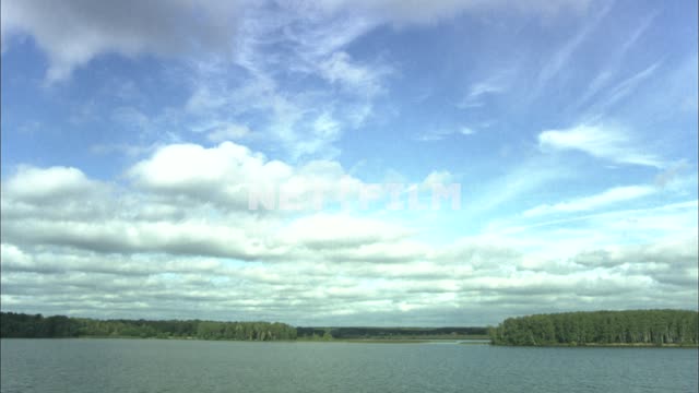 Panoramic view of a river with trees along the banks. Nature.
River.
Water.
Cloud.
The...