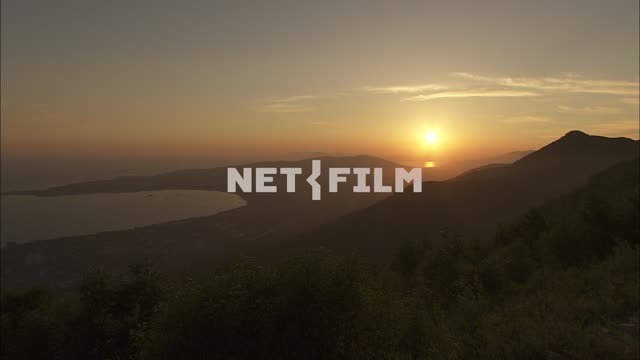 The view of the mountains and sea at sunset Nature.
The General plan
The sky.
The sun in the...