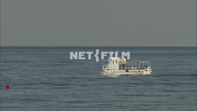 Pleasure boat sails on the sea Nature.
General plan.
Blue sea.
The boat is a...