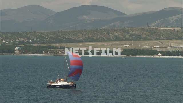 Sailing yacht in the sea. Nature.
Transport.
Sea.
Yacht.
On a clear day.
Mountains.
Planes.
Summer.