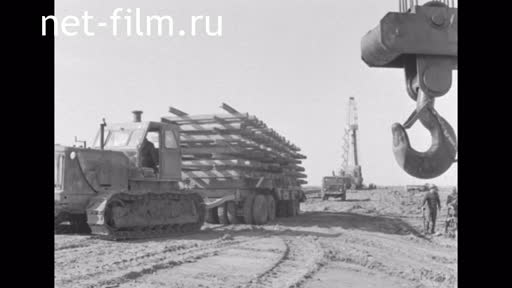 Footage Laying rails for a derrick. (1980)