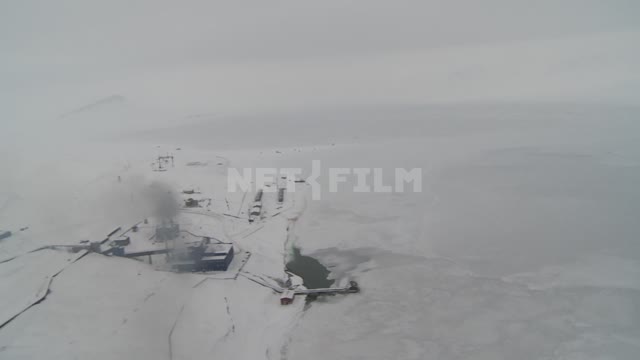 Shooting through the window of the helicopter infrastructure in the village of Barentsburg. Russian...