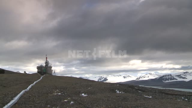 View standing on the hill station. Russian North, communications, radar, station, hill, clouds.