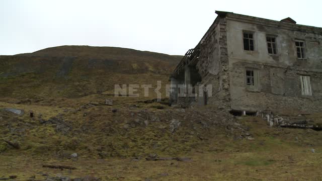 Abandoned buildings on the shore. Russian North, abandoned buildings, ruins, sea, mountains,...