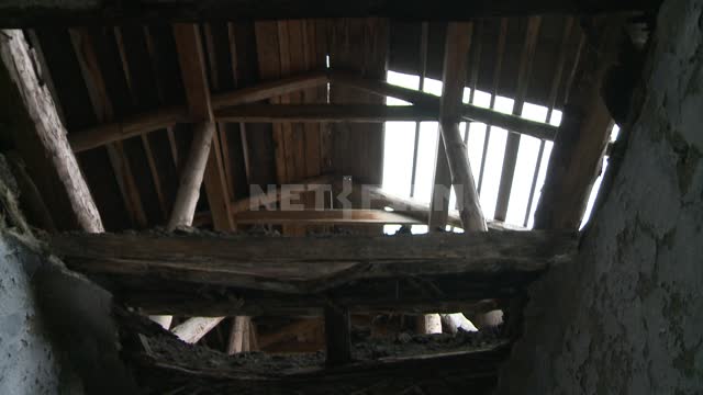 Inside view on the situation in an abandoned building. Russian North, roof, slabs, beams, ruins,...