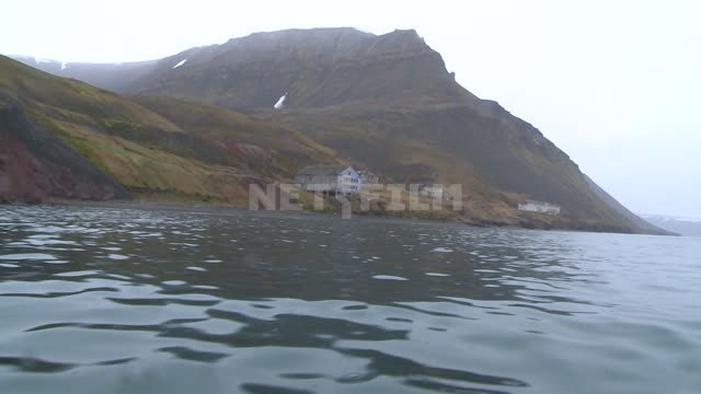 The view from the boat to shore and buildings in the village Pyramid. Russian North, building,...