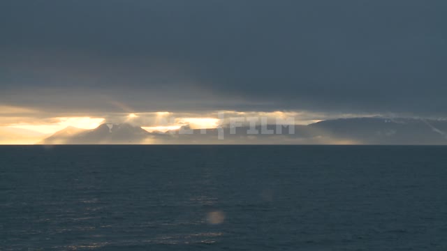 Mountain view from the sea.
 Russian North, mountains, sea, clouds, clouds, sunset.